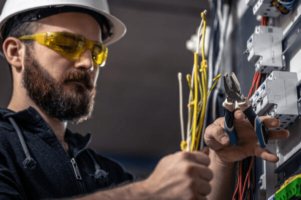 Licensed electrician working on an electrical switchboard in Newcastle NSW